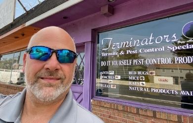 terminators pest control owner outside of diy shop